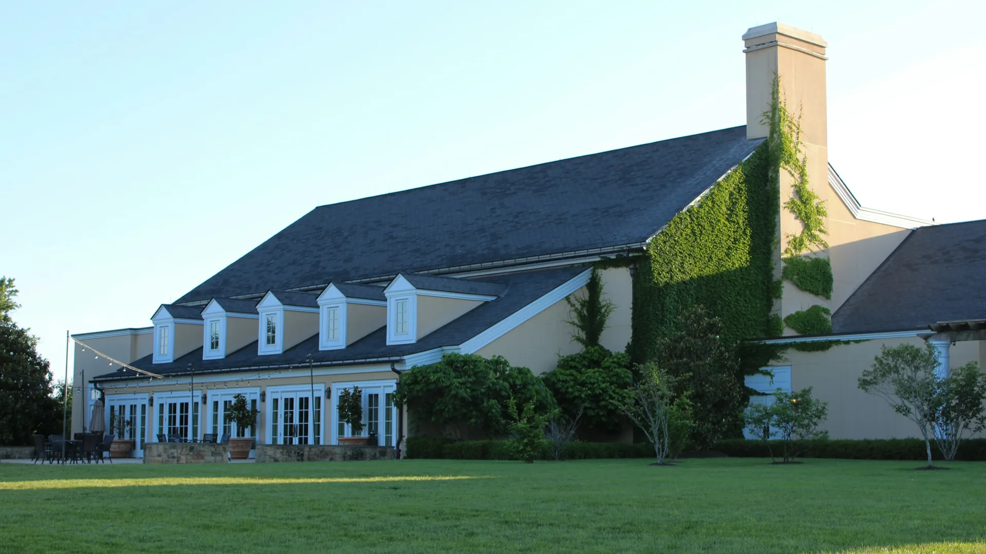 Large two-story suburban house with a green lawn
